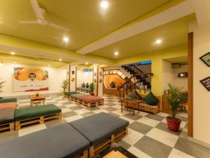 a living room with couches and a staircase in a room at Moustache Delhi in New Delhi +20 photos