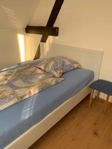 a bed in a room with a wooden floor at Gästezimmer Polster in Birstein +7 photos