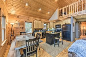 a kitchen and dining room with a table and chairs at Carolina Moon Cabin in Franklin