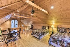 a bedroom with two beds and a table in a cabin at Carolina Moon Cabin in Franklin