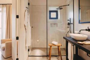 a bathroom with a glass shower and a sink at Finca Serena Mallorca, Small Luxury Hotels in Montuiri