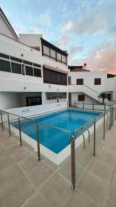 a swimming pool in front of a building at Apt In Colina 2, Los Cristianos K105 in El Guincho
