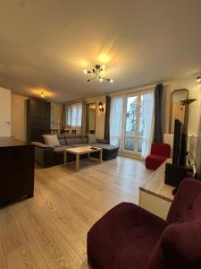 a living room with a couch and a table at Apparemment centre ville argenteuil 60m2 in Argenteuil