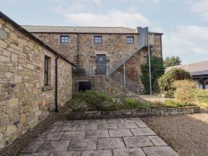an external view of a brick building with a staircase at Hollyhock in Wooler
