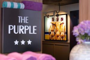 a sign that says the purple with a picture of boobs at The Purple Hotel - Adults Only in San Antonio