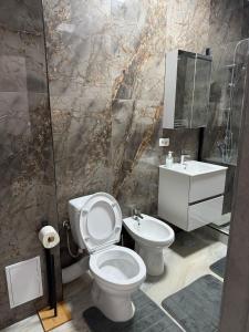 a bathroom with a toilet and a sink at Sea Breeze Residence 2 in Mamaia Nord +2 photos