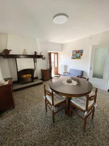 a living room with a table and a fireplace at Casa Ermy in Vercana