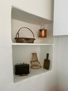 a shelf with a basket and other items on it at Casa Ermy in Vercana