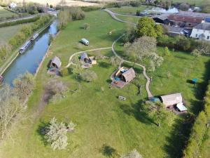 an aerial view of a park with tents next to a river at Hill Farm and Orchard in Leighton Buzzard