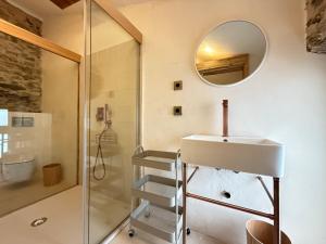 a bathroom with a shower and a sink and a mirror at Agi Porthos Apartments in Roses +42 photos