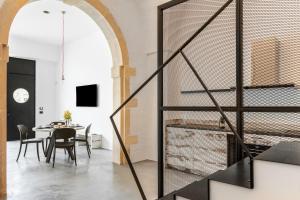 a room with a table and chairs and a glass wall at Opificio Angiolino Luxury Residence in Melendugno
