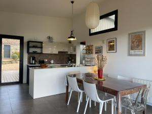 a kitchen and dining room with a table and chairs at A Casuccia in Zonza