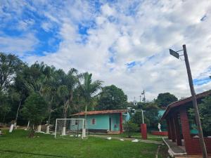 a house with a street light in a yard at Chácara Falcão in Itapeva +4 photos