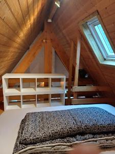 a bedroom with a white bed in a attic at Calmos Cottage in Barneville-Carteret