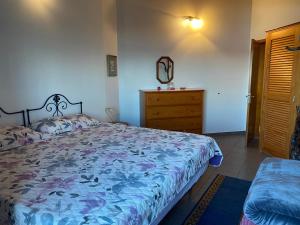 a bedroom with a large bed and a dresser at Adega Baia do Canto AL 1398 in Terra Alta