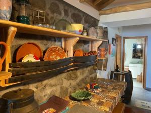 a kitchen with a table with plates on a wall at Adega Baia do Canto AL 1398 in Terra Alta