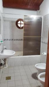 a bathroom with a shower and a sink and a toilet at Casa tafi del valle in Tafí del Valle