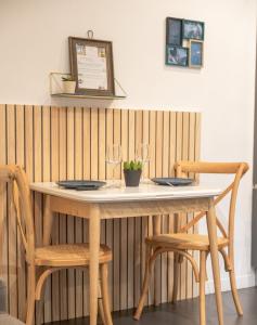 a table with two chairs and two wine glasses at Les Sablettes in Menton