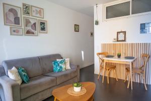 a living room with a couch and a table at Les Sablettes in Menton
