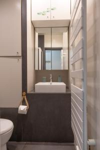 a bathroom with a sink and a mirror at Les Sablettes in Menton
