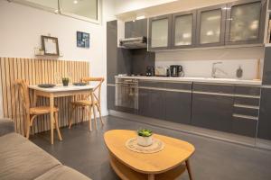 a living room with a table and a kitchen at Les Sablettes in Menton