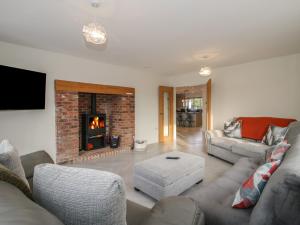 a living room with a couch and a fireplace at Leys Retreat in Bishops Castle