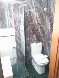 a bathroom with a toilet and a glass shower at Hotel MM Dateo in Milan +77 photos
