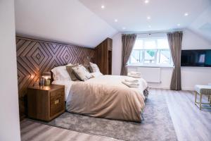 a bedroom with a large bed and a window at Pencoed House Estate (Cardiff) in Cardiff +101 photos