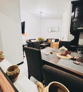 a living room with a table and couches at Casa Orquídeas Oaxaca in Oaxaca City +3 photos