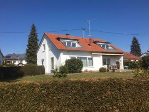 uma casa branca com um telhado laranja em Appartement Zahn em Bad Waldsee