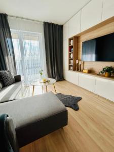 a living room with a bed and a table at Apartmán s parkovacím miestom in Nitra