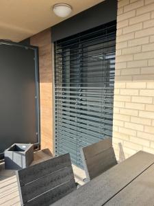 a room with a table and two chairs and a large window at Apartmán s parkovacím miestom in Nitra