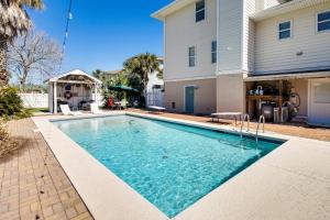 a swimming pool in front of a house at Tybee Island Gem: Spacious Home w/ Private Pool in Tybee Island