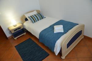 En eller flere senger på et rom på Pro Touristic Casa Montejunto