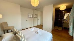 a bedroom with a bed with two shoes on it at La Villa Saint Germain in Saint-Valery-sur-Somme