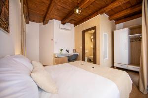 a bedroom with a large white bed and a bathroom at Rooms Natura in Vilanija +144 photos