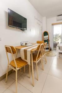 a dining room with a table and chairs and a tv at 4-Pax Studio w FREE Parking, 5 mins to Sky Ranch in Tagaytay