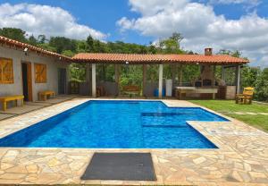 a swimming pool in a yard with a gazebo at Espaço Vila do Vale in São Roque