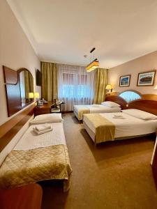 Postel nebo postele na pokoji v ubytování Cumulus Hotel + 88 fotografií