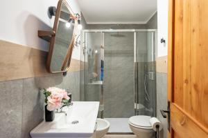 a bathroom with a shower and a toilet and a sink at Montagne E Coccole - Happy Rentals in Pré-Saint-Didier