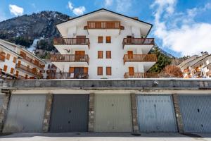 a building with two garage doors in front of it at Montagne E Coccole - Happy Rentals in Pré-Saint-Didier
