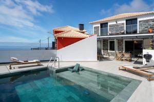 eine Villa mit Swimmingpool und ein Haus in der Unterkunft Villa Island Roots by An Island Apart in Calheta + 35 Fotos