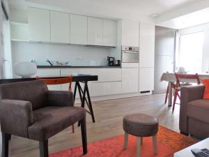 a kitchen and living room with a table and chairs at Tulipe Saint Gilles Croix de Vie in Saint-Gilles-Croix-de-Vie