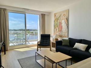 un salon avec un canapé et une grande fenêtre dans l'établissement Corsaire Saint Gilles Croix de Vie, à Saint-Gilles-Croix-de-Vie