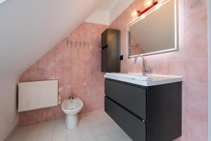 a bathroom with a sink and a toilet at Maison entre terre et mer in Pluvigner +13 photos
