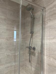 a shower with a shower head in a bathroom at Two Bedroom City View Apartment Liverpool in Liverpool +65 photos