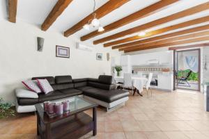 a living room with a couch and a table at Holiday House with Private Pool Villa Ladybug in Milotski Breg