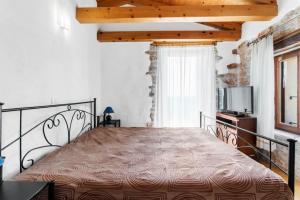 a bedroom with a large bed in a room at Holiday House with Private Pool Villa Ladybug in Milotski Breg +17 photos