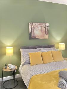 a bedroom with a bed with yellow pillows at Ideal 3 bed pay-as-you-stay home in Wigan sleeps 6 in Wigan