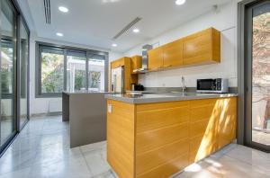 a kitchen with wooden cabinets and a counter top at DownTown Villa 2 in Paphos